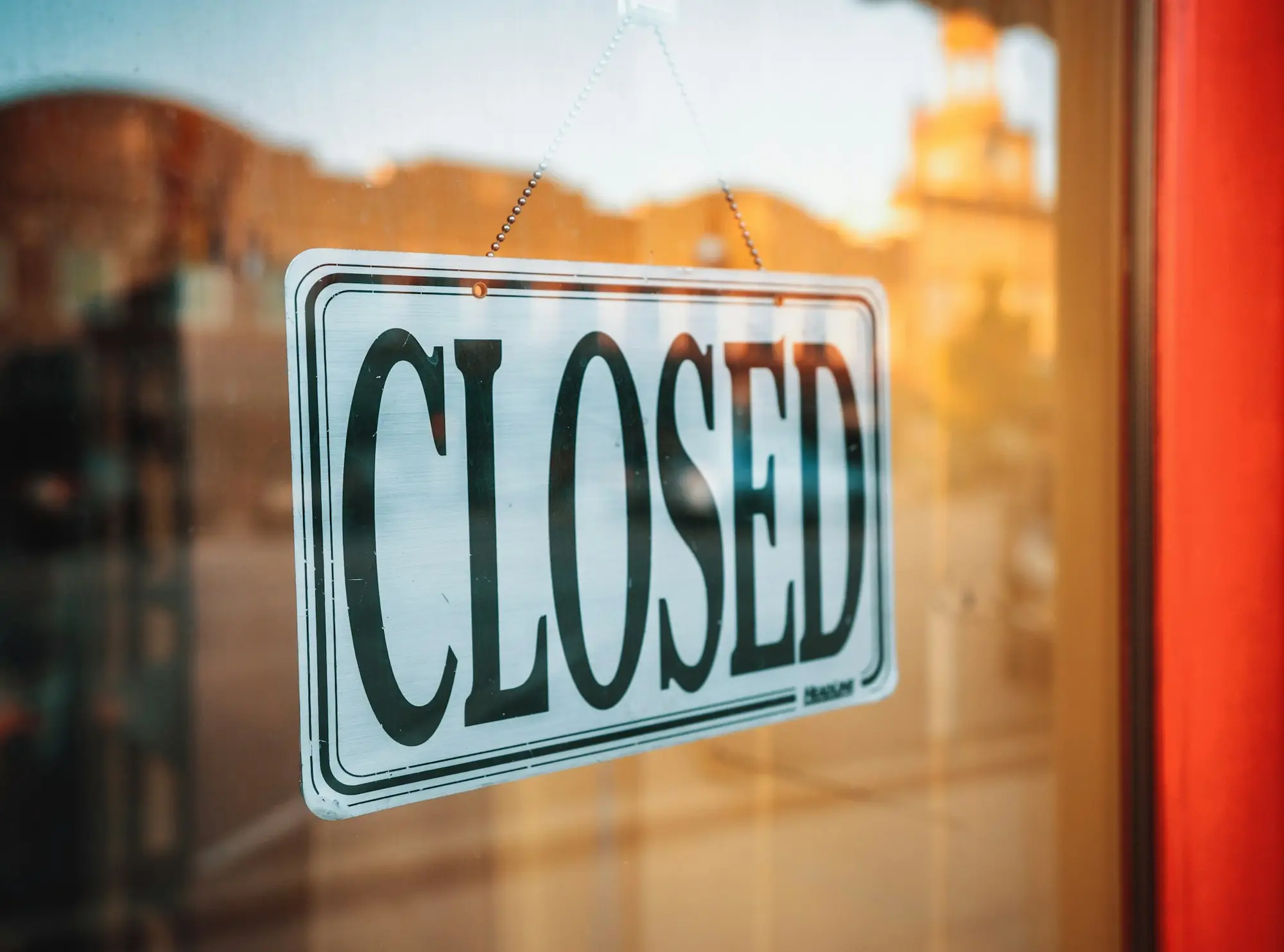 Closed sign hanging in a shop window